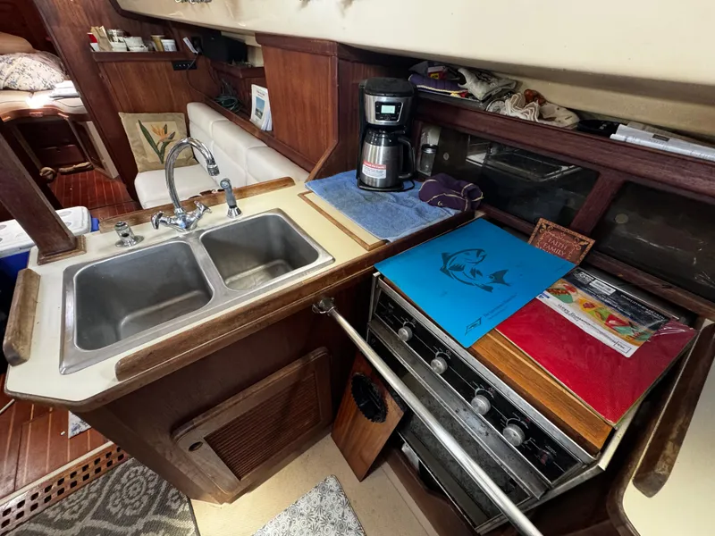 Slide: The Image of Interior of 1989 Island Packet 35 sailboat with cozy seating and nautical decor. - 54