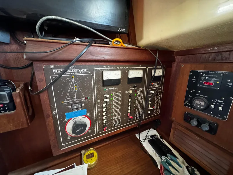 Slide: The Image of Interior of a 1989 Island Packet 35 sailboat, featuring a compact kitchen and cozy living space. - 56