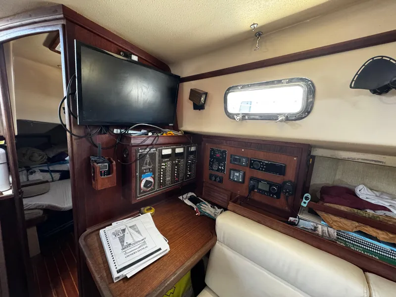 Slide: The Image of Interior of 1989 Island Packet 35 sailboat with cozy seating and nautical decor. - 58