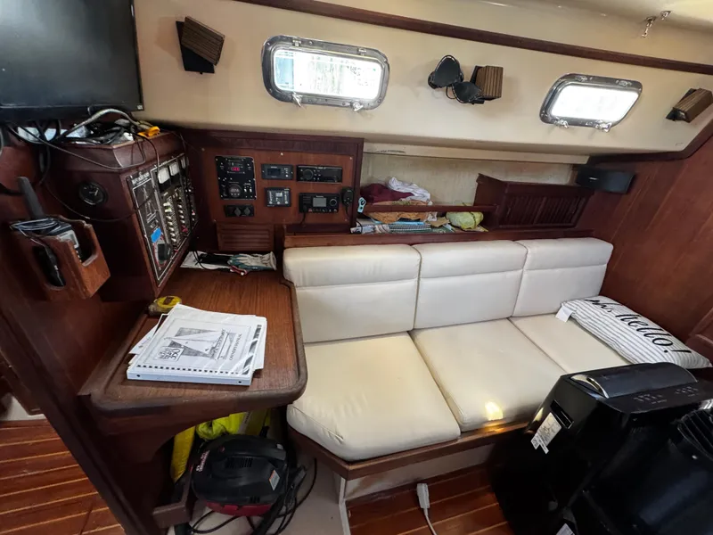 Slide: The Image of 1989 Island Packet 35 yacht interior with navigation station, seating, and storage. - 59