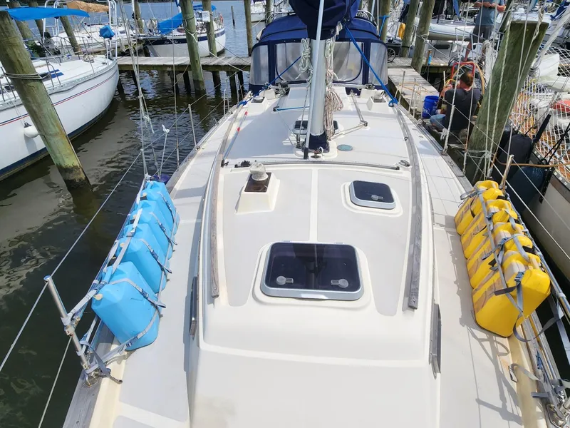 Slide: The Image of 1989 Island Packet 35 sailboat deck with hatches, docked at marina. - 6