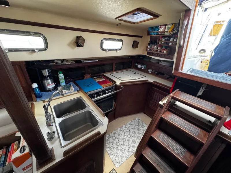 Slide: The Image of Red microwave inside 1989 Island Packet 35 yacht kitchen area. - 61