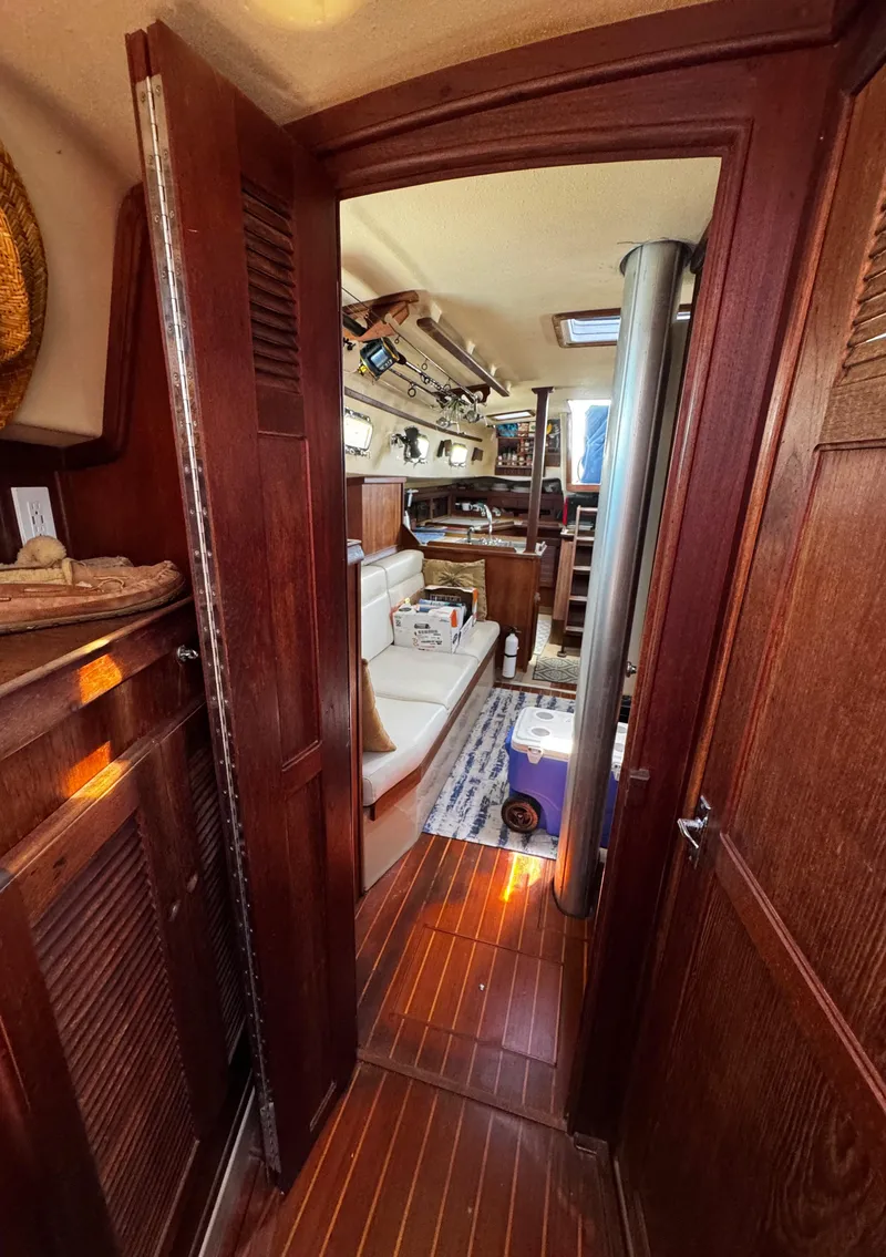 Slide: The Image of Cozy cabin interior of 1989 Island Packet 35 sailboat with cushions and pillows. - 70