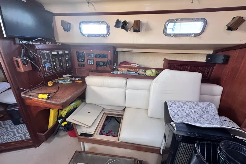 Slide: The Image of Interior of a 1989 Island Packet 35 sailboat with navigation station and seating area. - 73