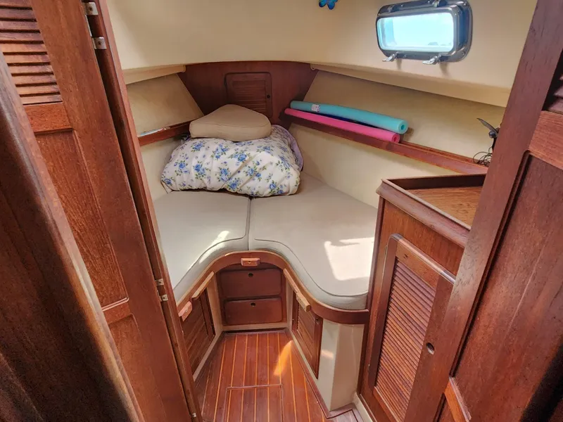 Slide: The Image of 1989 Island Packet 35 sailboat cabin with cozy V-berth and wooden interior. - 75