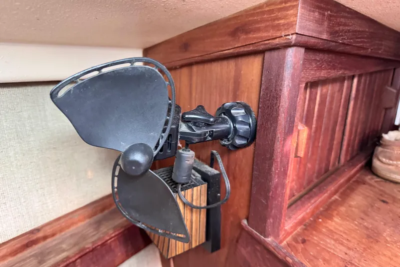 Slide: The Image of Small fan mounted on wooden interior of 1989 Island Packet 35 sailboat. - 85