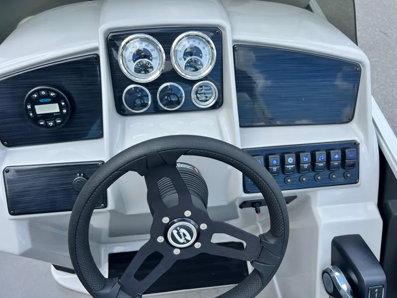 Slide: The Image of 2022 Sylvan Mirage 820 CRS C dashboard with steering wheel and control panel. - 10