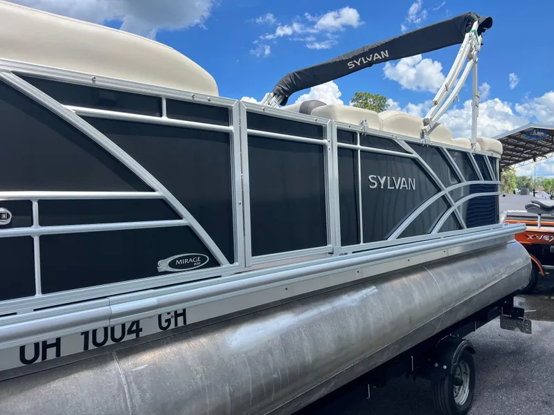 Slide: The Image of 2022 Sylvan Mirage 820 CRS C pontoon boat with black exterior and registration number. - 3