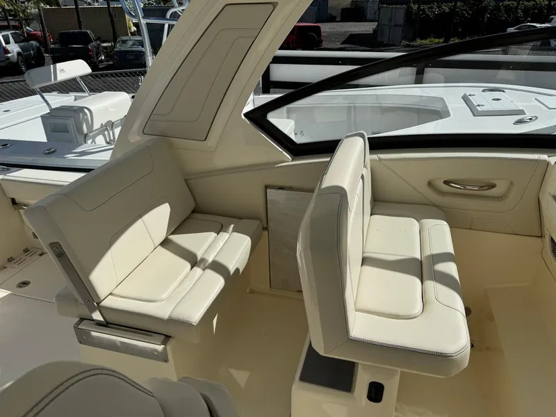 Slide: The Image of 2025 Scout 277 Dorado boat interior with beige seating and modern design. - 13
