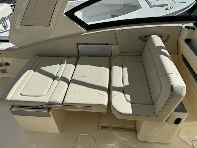 Slide: The Image of 2025 Scout 277 Dorado boat interior with beige leather seating and modern design. - 15