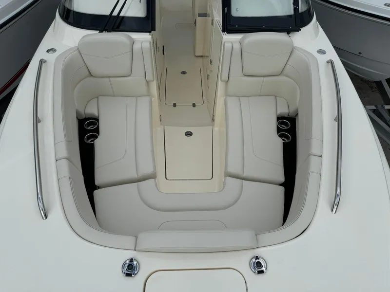 Slide: The Image of 2025 Scout 277 Dorado boat interior with luxurious seating and cup holders. - 16