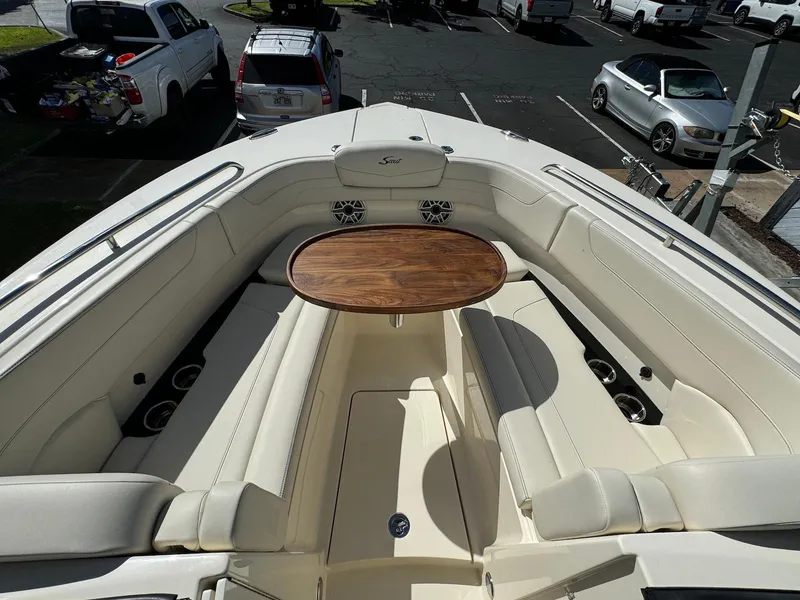 Slide: The Image of 2025 Scout 277 Dorado boat interior with seating and wooden table. - 17