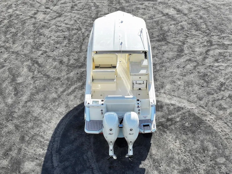 Slide: The Image of 2025 Scout 277 Dorado boat, aerial view, dual engines, sleek design on a textured surface. - 5