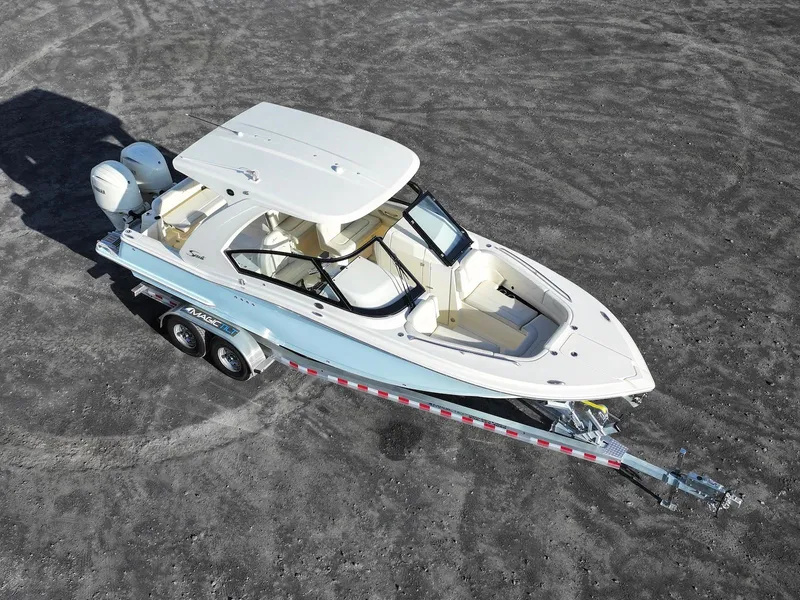 Slide: The Image of 2025 Scout 277 Dorado boat on trailer, aerial view, parked on gravel surface. - 8