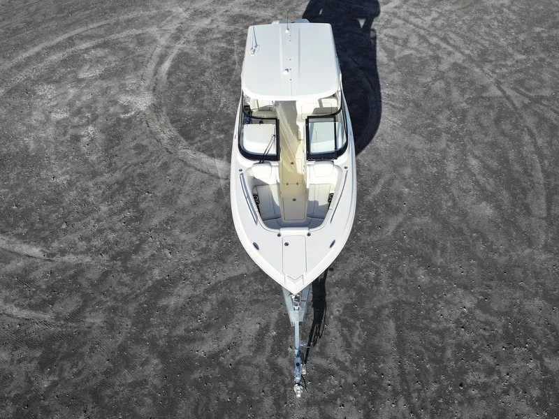 Slide: The Image of 2025 Scout 277 Dorado boat, aerial view on sandy terrain, showcasing sleek design and modern features. - 9