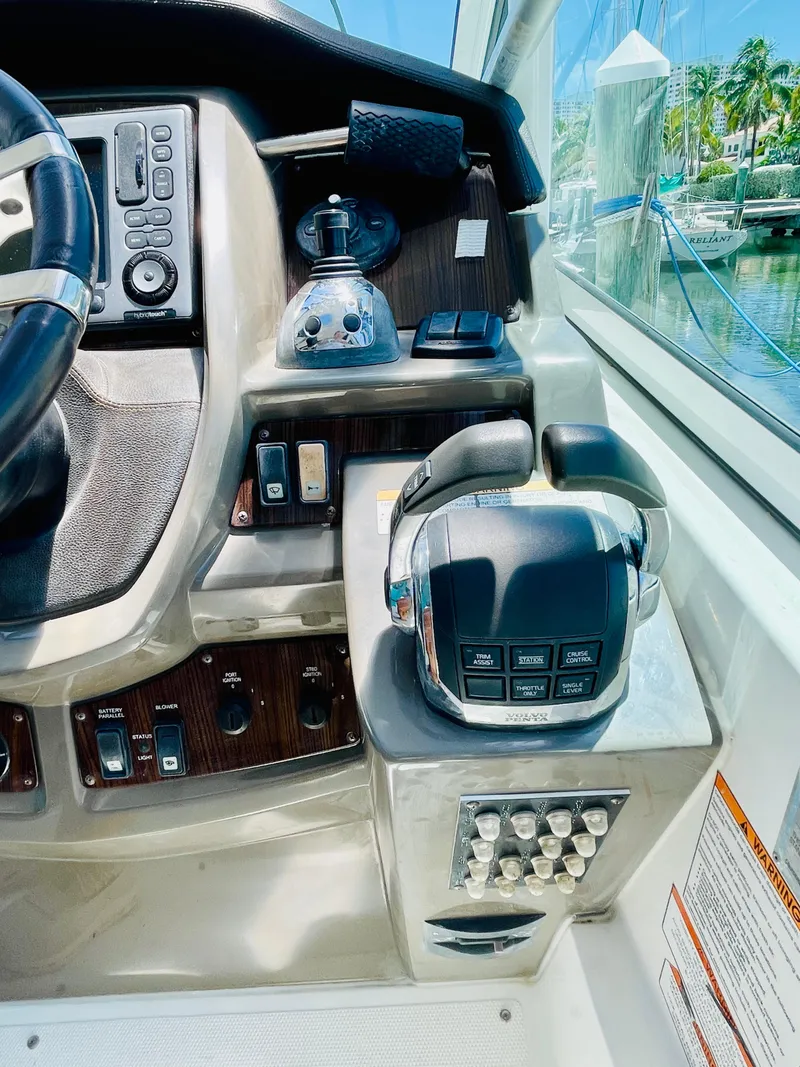 Slide: The Image of Control panel of a 2012 Cruisers 350 Express yacht with throttle and navigation controls. - 10