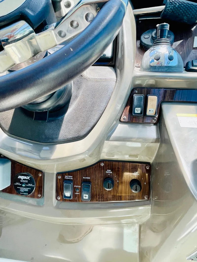 Slide: The Image of Control panel of a 2012 Cruisers 350 Express boat with steering wheel and switches. - 11