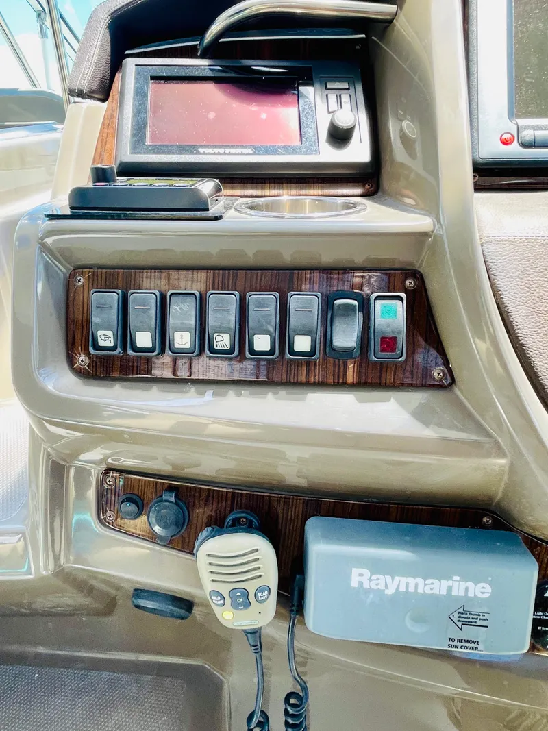 Slide: The Image of Control panel of a 2012 Cruisers 350 Express boat with Raymarine equipment. - 12