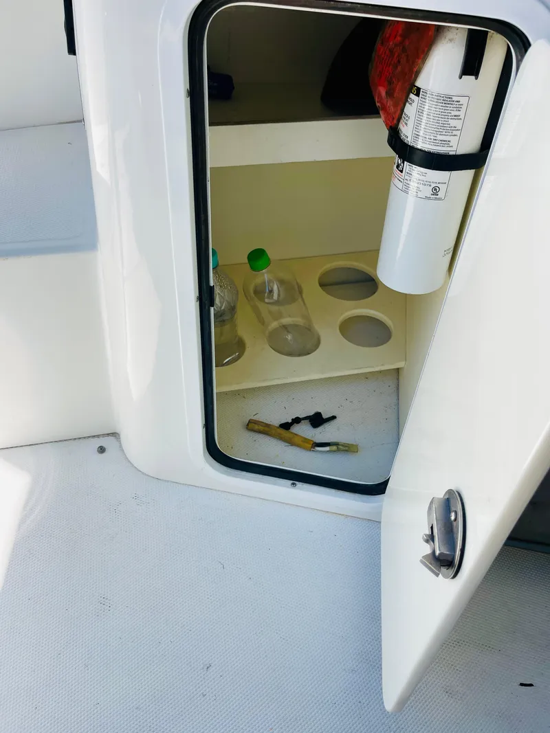 Slide: The Image of Open storage compartment on a 2012 Cruisers 350 Express boat. - 21