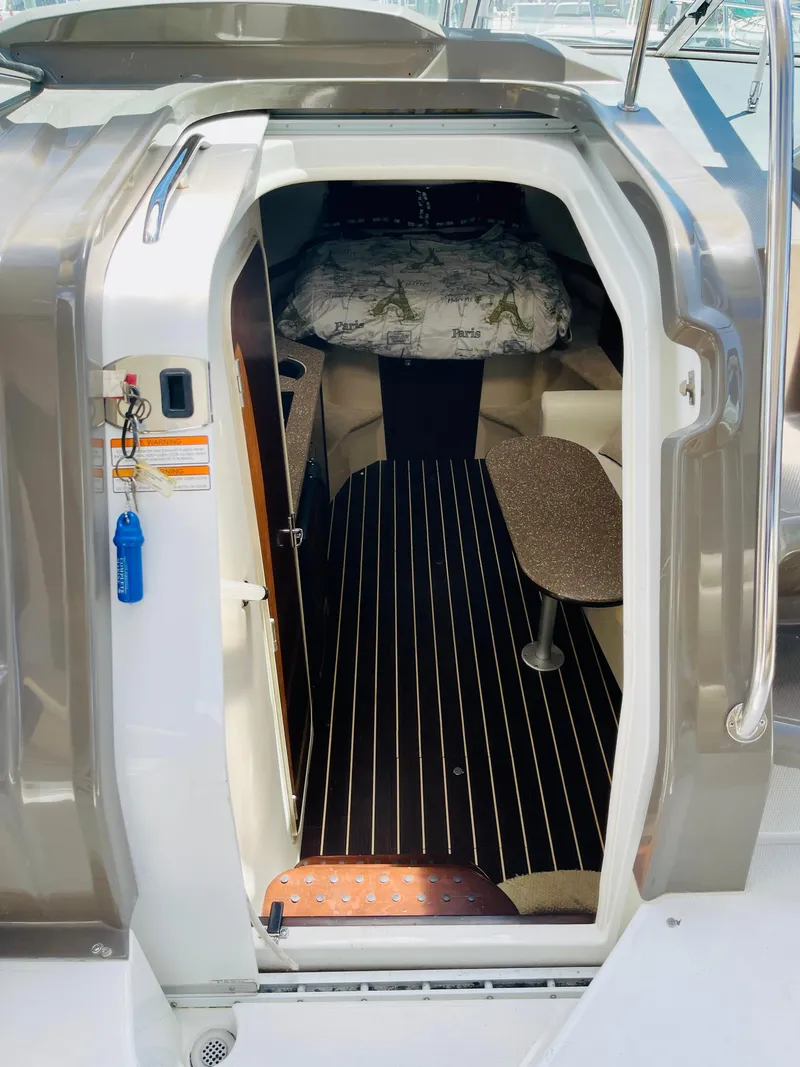 Slide: The Image of 2012 Cruisers 350 Express cabin interior with bed and seating area. - 22