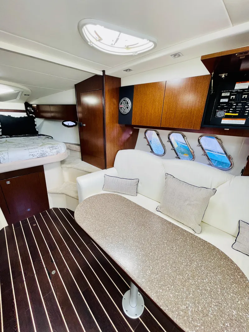 Slide: The Image of Interior of 2012 Cruisers 350 Express yacht with modern seating and dining area. - 25