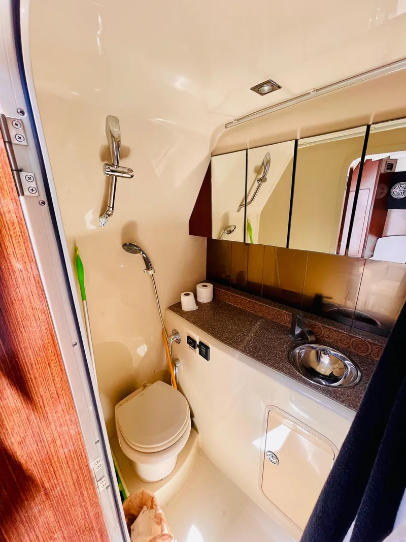 Slide: The Image of 2012 Cruisers 350 Express bathroom with shower, sink, and mirror. - 29