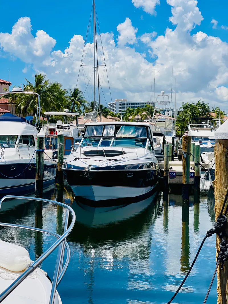 Slide: The Image of 2012 Cruisers 350 Express docked at a marina on a sunny day. - 3