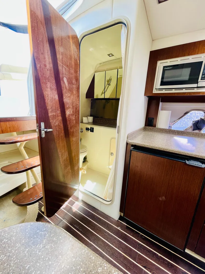 Slide: The Image of Interior of a 2012 Cruisers 350 Express yacht showing a bathroom and kitchenette. - 31