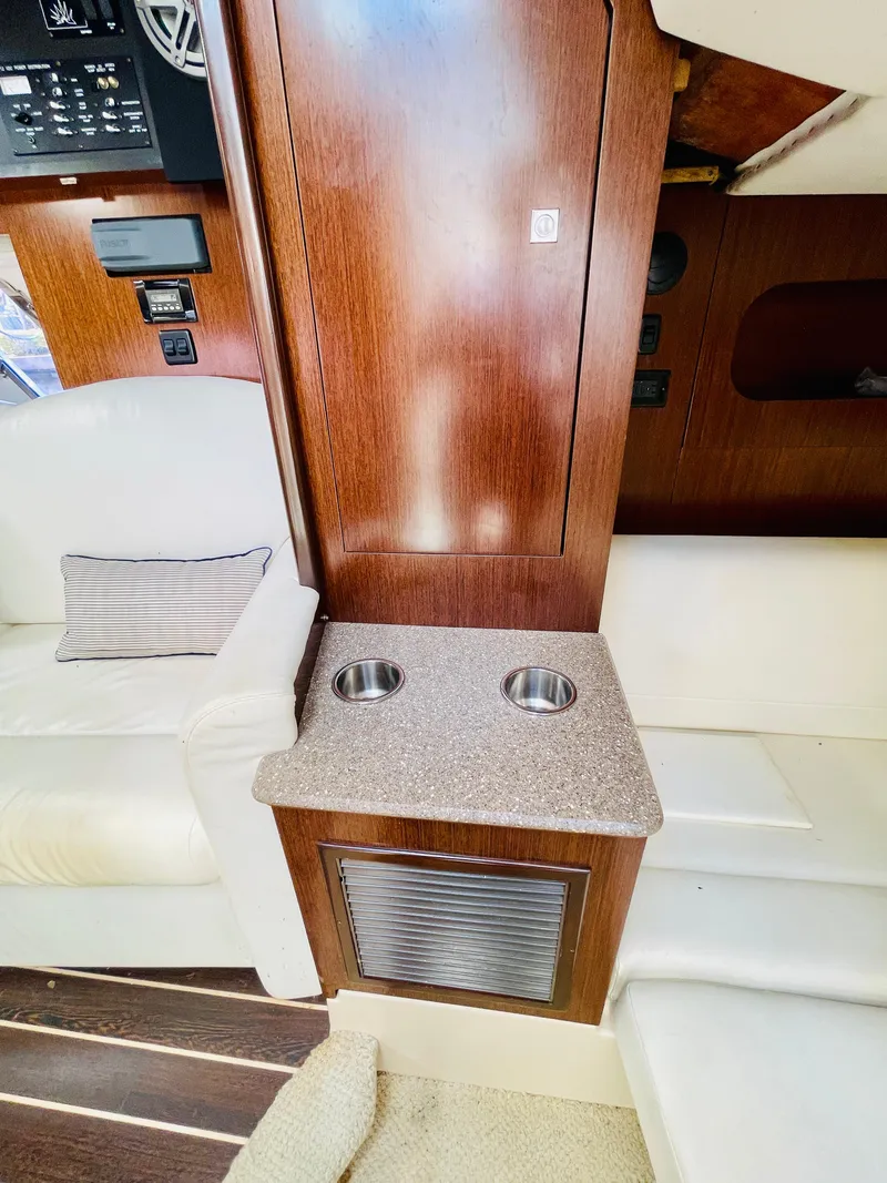 Slide: The Image of 2012 Cruisers 350 Express cabin interior with seating and cup holders. - 32