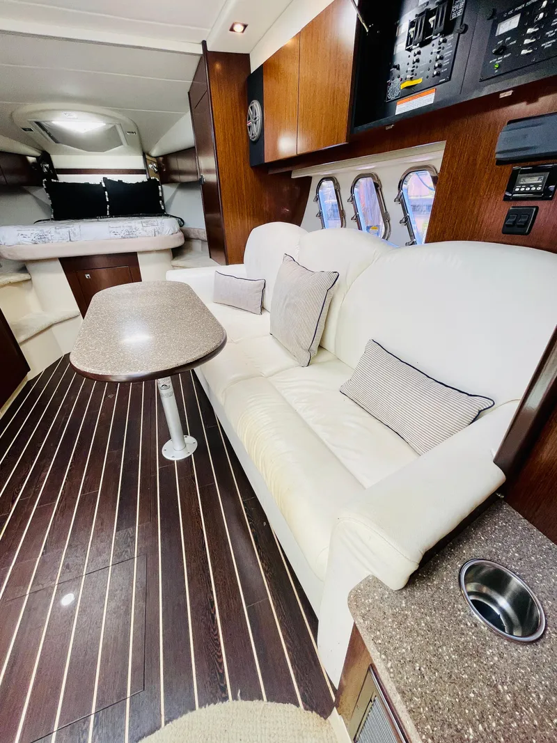 Slide: The Image of Interior of 2012 Cruisers 350 Express yacht with white leather seating and wooden flooring. - 33