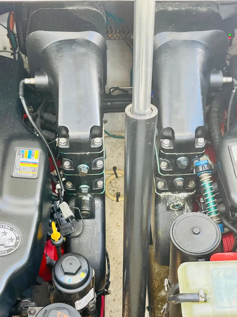 Slide: The Image of Engine compartment of a 2012 Cruisers 350 Express boat showing dual engines and components. - 38