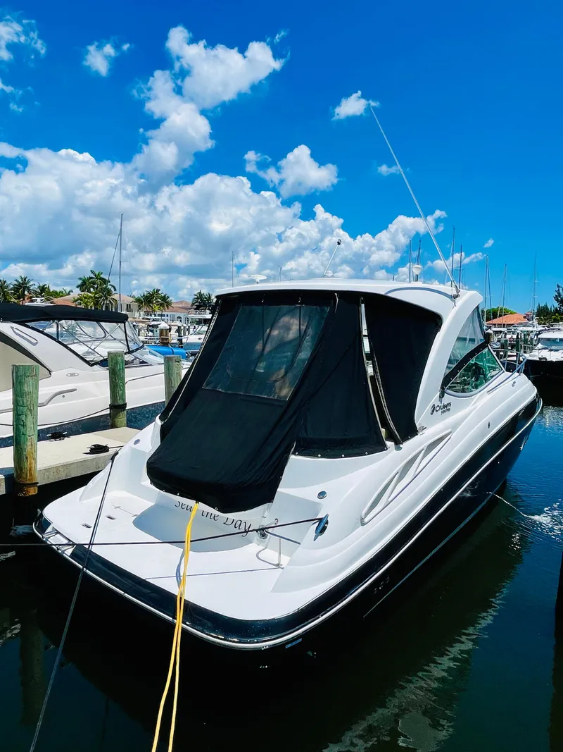 Slide: The Image of 2012 Cruisers 350 Express yacht docked at a marina on a sunny day. - 4