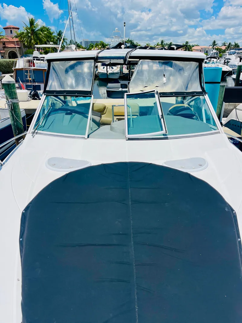 Slide: The Image of 2012 Cruisers 350 Express yacht docked at a marina on a sunny day. - 48