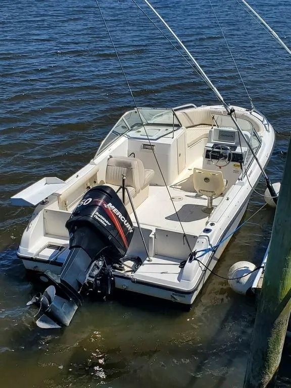 Slide: The Image of 2006 Mako 195DC boat with Mercury outboard motor on the water. - 2