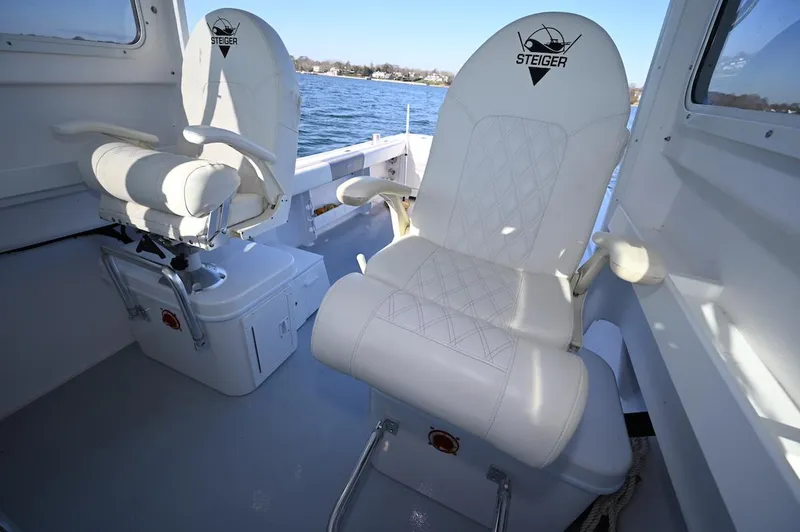 Slide: The Image of 2025 Steiger Craft 255 Miami boat interior with white cushioned seats. - 12