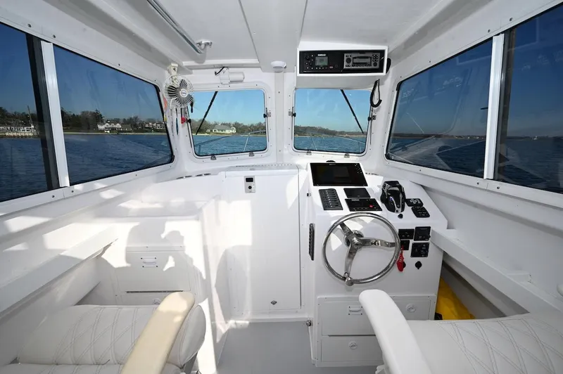 Slide: The Image of Interior of 2025 Steiger Craft 255 Miami boat with modern controls and panoramic windows. - 5