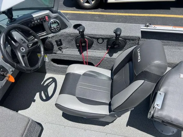 Slide: The Image of 2017 Lund Impact XS 1850 boat interior with steering wheel and seating. - 15
