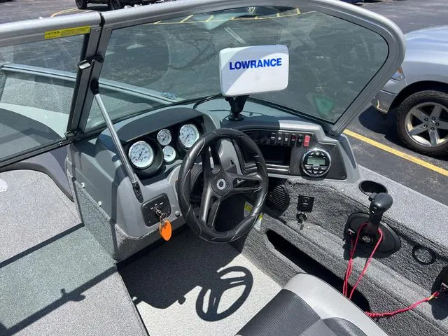 Slide: The Image of 2017 Lund Impact XS 1850 boat cockpit with Lowrance electronics and steering wheel. - 16