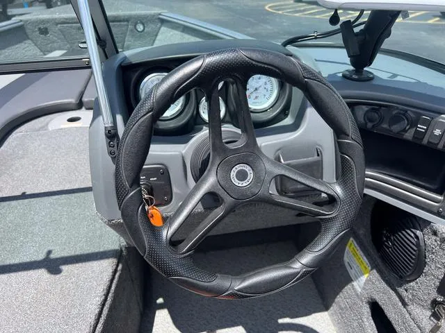 Slide: The Image of 2017 Lund Impact XS 1850 boat steering wheel and dashboard controls. - 20