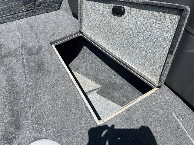Slide: The Image of 2017 Lund Impact XS 1850 boat storage compartment with open hatch. - 27