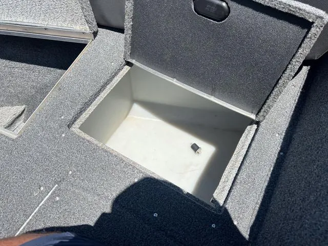 Slide: The Image of 2017 Lund Impact XS 1850 boat storage compartment with open lid. - 28