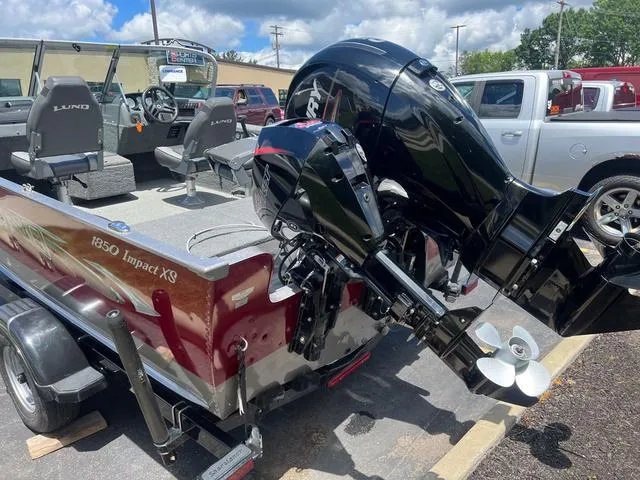 Slide: The Image of 2017 Lund Impact XS 1850 boat with outboard motor in parking lot. - 4