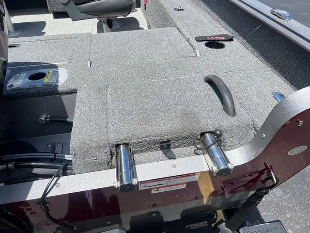 Slide: The Image of 2017 Lund Impact XS 1850 boat interior with carpeted deck and storage compartments. - 5