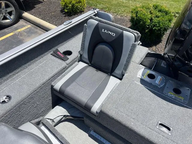 Slide: The Image of 2017 Lund Impact XS 1850 boat interior with gray seating and storage compartments. - 7