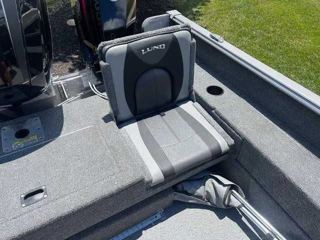 Slide: The Image of 2017 Lund Impact XS 1850 boat interior with cushioned seating and motor. - 8