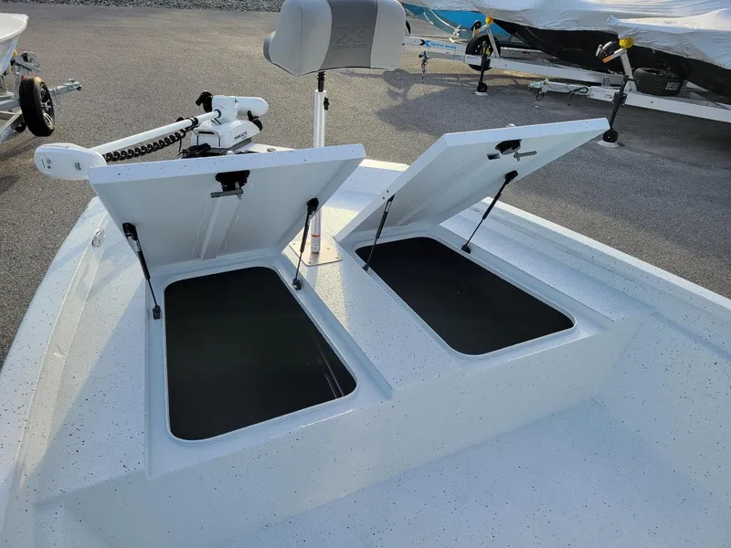 Slide: The Image of 2025 Xpress H190 Bay Boat with open storage compartments and trolling motor. - 14