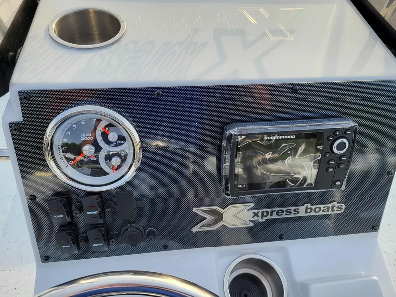 Slide: The Image of 2025 Xpress H190 Bay Boat dashboard with gauges and navigation system. - 7