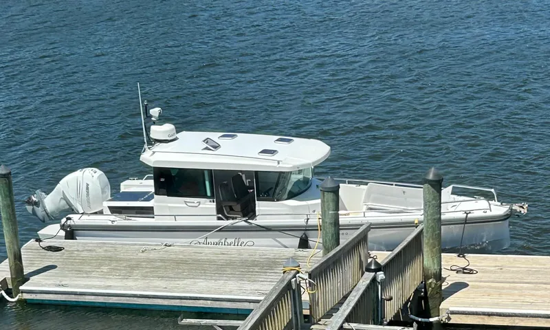 Slide: The Image of 2018 Axopar Mark II boat docked at a marina. - 11
