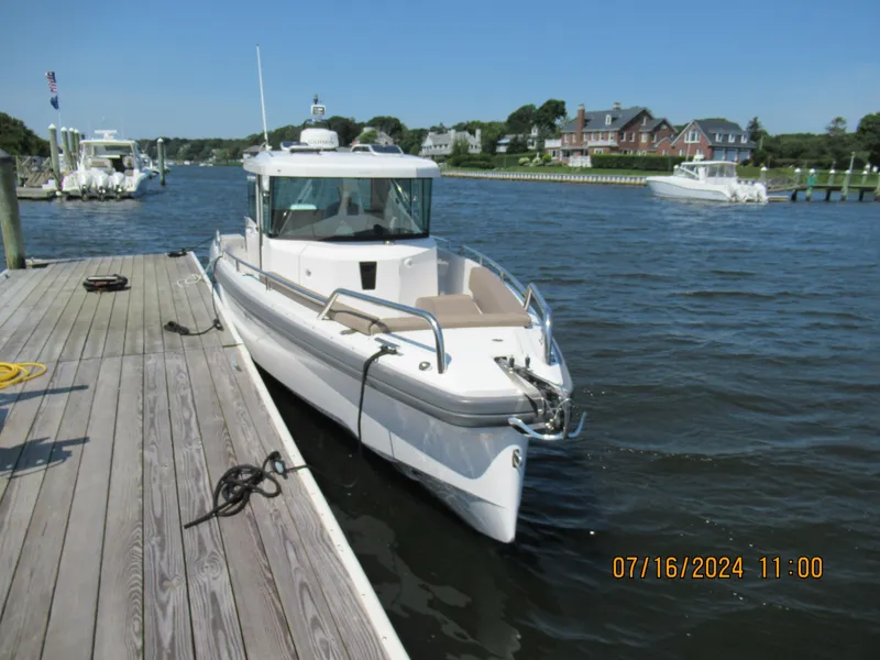 Slide: The Image of Axopar Mark II 2018 boat docked at a marina on a sunny day. - 14