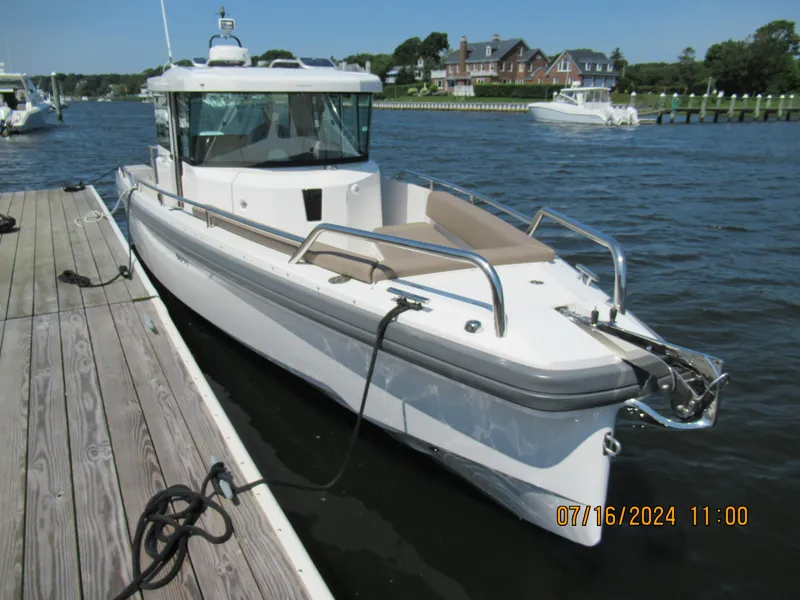 Slide: The Image of Axopar Mark II 2018 boat docked at a marina on a sunny day. - 15